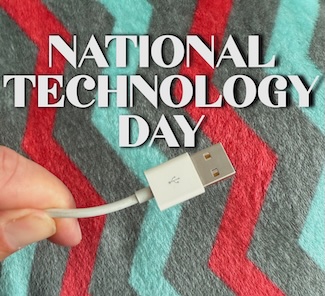 a hand holding a USB-A cable end for national technology day