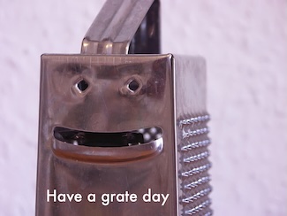 a cheese grater that appears to be smiling
