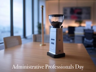 a modern coffee grinder sitting on an office conference room table, next to a stripper pole