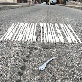 a plastic fork in the middle of a road for national trails day in June 