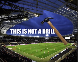 a large hammer over a soccer match in a stadium