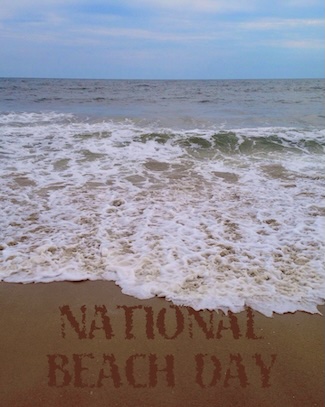 small waves crashing on a beach on a partly cloudy day