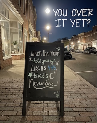 A fun sign about November outside of a small town store on main street