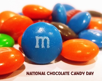 a handful of colorful M&M chocolate candy for the national celebration of chocolate in December