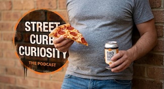 a typical dad bod style body of a guy, who is holding some pizza and a beer