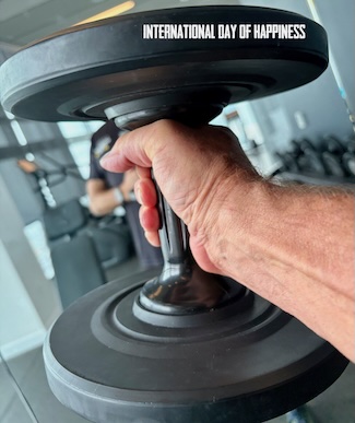a man holding a weight in a gym during a workout