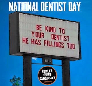 a funny sign under blue skies saying you should be kind to your dentist.