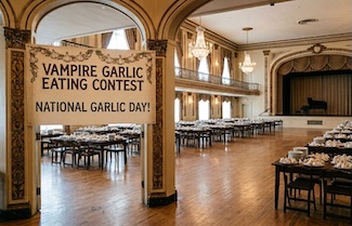 a large empty ballroom, st up for a vampire garlic eating contest or competition on national garlic day in April.