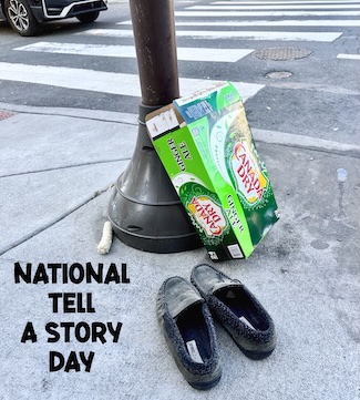 a discovery of an eaten corn cob, a dirty pair of slippers and an empty ginger ale soda case on a city sidewalk, as a moment of curiosity for national tell a story day in April.