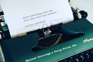 a green typewriter with a sheet of paper that has some wise words about writing typed on them, but no one knows who the author is.