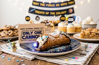 A cannoli among other favorite sweet treats from the USA, such as apple pie, cookies and cupcakes for national dessert day